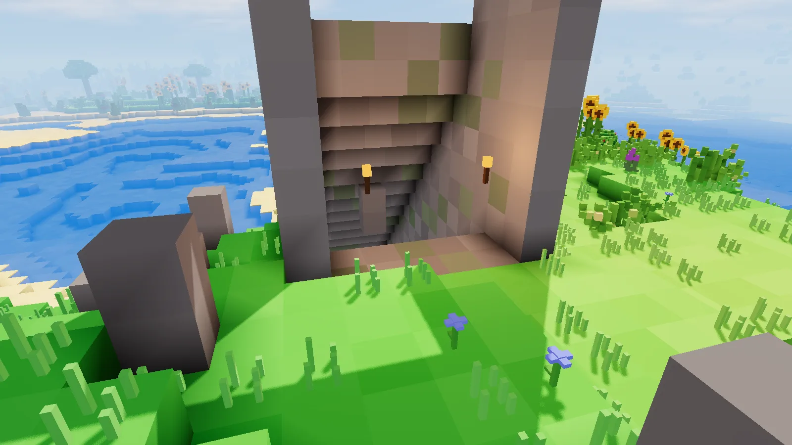 The stone portal and stair of a dungeon on a hillside by the sea